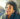 black woman smiling listening with earbud headphones